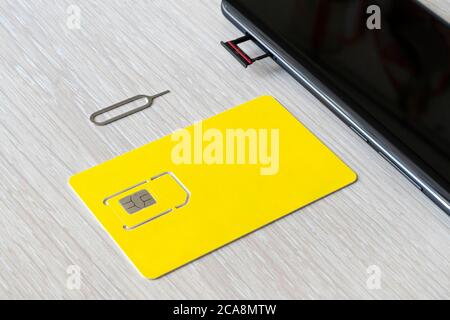 Replacement of nano sim card chip in modern smartphone, Close-up view. copyspace, empty space for design and lettering Stock Photo