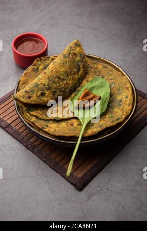 Palak Paratha is a delicious and healthy and tasty Indian flatbread made from mildly spiced whole wheat flour and spinach Stock Photo