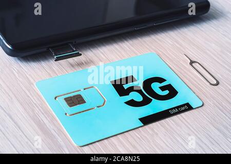 Two sim cards, phone and computer. 5G fifth generation of mobile communications Stock Photo