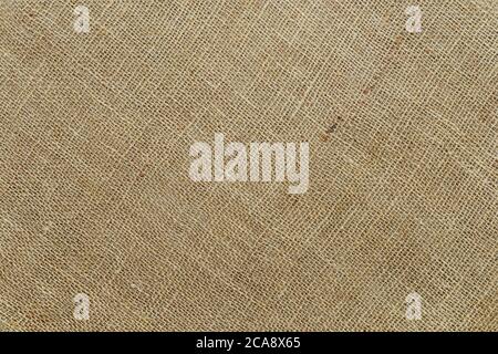 Diagonal burlap texture of natural color. Sackcloth rustic canvas background. Rough fabric woven of flax, jute or hemp. Design element. Top view. Stock Photo