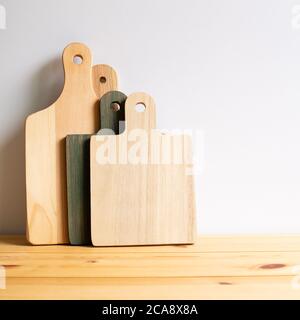 Wooden tray, cutting board, plate on wooden table with white background Stock Photo