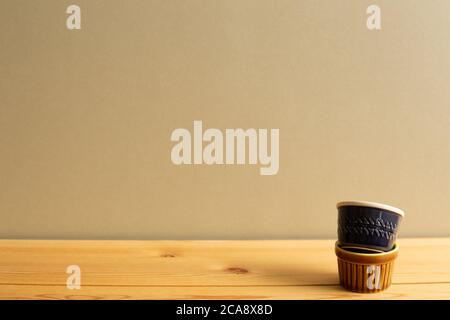 Stack of ceramic bowls on wooden table with brown background Stock Photo