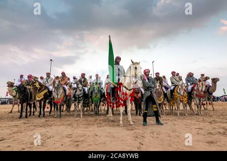 Saudi Arab Camel riders with their camels on traditional desert safari