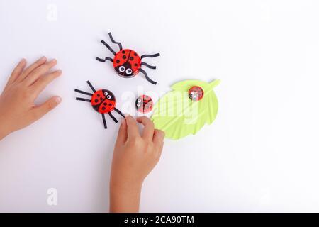 Paper crafts for children. Application of children's creativity.  Kindergarten and craft school. On a beige background, a funny face of a man  made of colored paper. 18906892 Stock Photo at Vecteezy