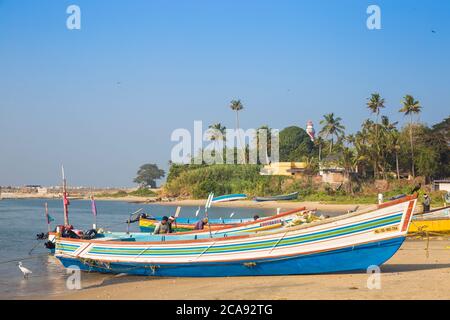 Fishing boats on beach with Tangasseri Lighthouse in background, Kollam, Kerala, India, Asia Stock Photo