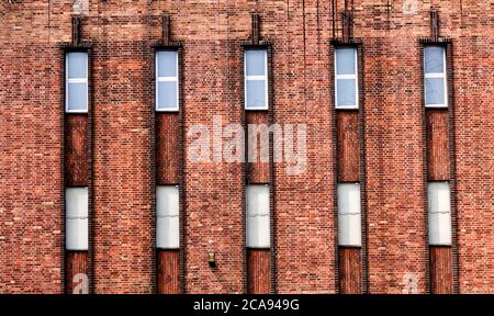 Abstract view of an old brick building with elongated rectangular windows Stock Photo