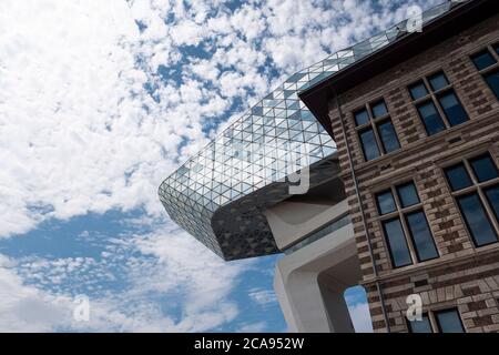 Antwerp, Belgium, July 19, 2020, Cloudy sky reflected in the glass on the detail photo of the harbor house at the port Stock Photo