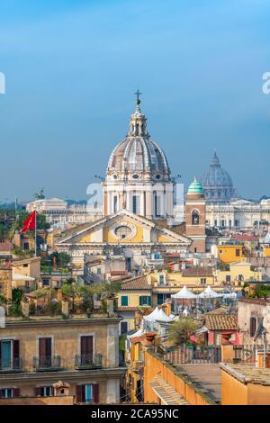 Basilica of SS. Ambrose and Charles on the Corso and St. Peter's Basilica and Vatican beyond, Rome, Lazio, Italy, Europe Stock Photo