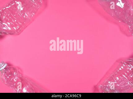 Plastic bottles isolated on pink background. Recycle waste management concept. Plastic Pet Bottles. Photo frame. Stock Photo