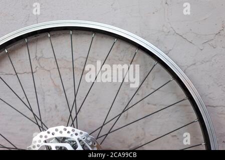 a double rim of a bicycle wheel without a tire, against a background of a textured eraser. Bicycle wheel repair, hub, bicycle iron rim Aluminum bicycl Stock Photo
