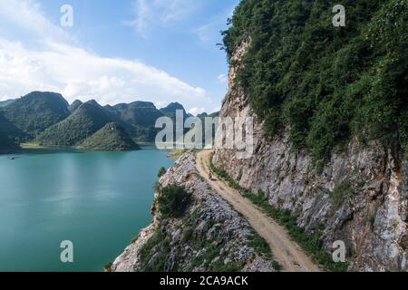 aerial view of a villager is riding on tough high mountain road Stock Photo