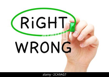 Hand drawing a concept about making the Right choice instead of the Wrong one with marker on transparent wipe board. Stock Photo