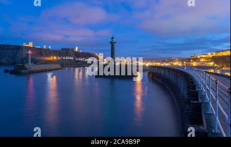 View of the entrance to Whitby Harbour at dusk Stock Photo