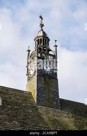Public clock tower on roof of Redesdale Hall against blue sky. Moreton-in-Marsh, Gloucestershire, Cotswolds, England, UK, Britain Stock Photo