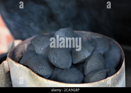 Charcoal/coal briquettes in the fire on the grill Stock Photo