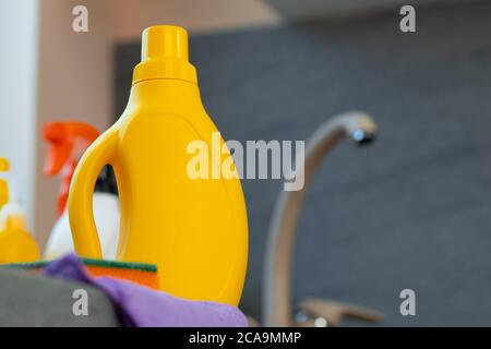 Household chemicals product bottles standing near the kitchen sink Stock Photo