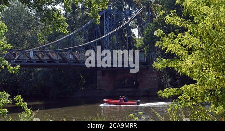 05 August 2020, Saxony-Anhalt, Halle (Saale): A boat passes under the Peißnitz bridge on the river Saale. Cool places at and on the water will also be in demand during the next days. In many places in Germany the thermometer rises above 30 degrees Celsius. Photo: Hendrik Schmidt/dpa-Zentralbild/dpa Stock Photo