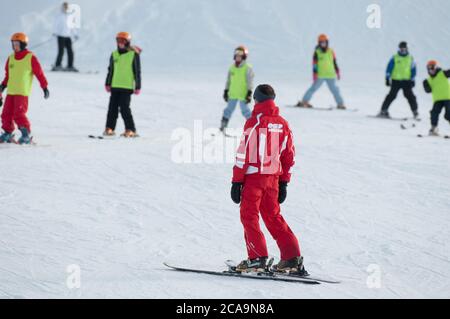 Learning to ski with ESF ski school on the slopes of the French ski resort of Morzine in the Haute-Savoie region of South Eastern France. Stock Photo