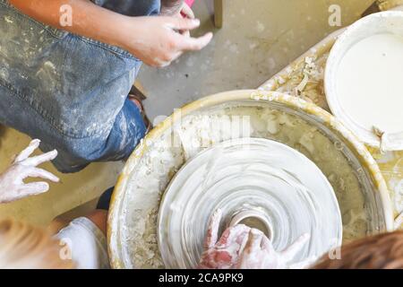 Children making pottery during ceramic lesson with clay Stock Photo