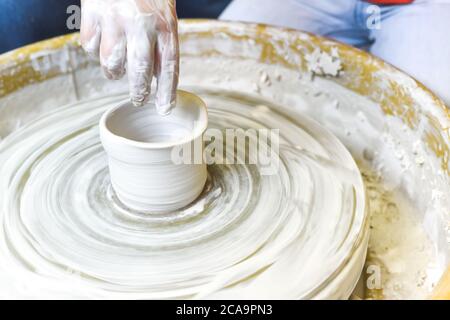 Children making pottery during ceramic lesson with clay Stock Photo