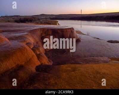 Natural terraces, consisting of travertine deposits at Crystal Geyser, Green River, Utah, USA, in the early evening Stock Photo