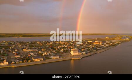 Rain falls as sun shines in the middle of the night at Kotzebue Alaska creating a beautiful contrast between the sunrise and storm Stock Photo