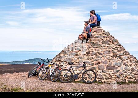 Exmoor National Park - Mountain bikers enjoying the view from the cairn marking the highest point on Exmoor, Dunkery Beacon 1705 feet 520 metres, Some Stock Photo