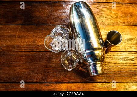 Bar ustensils, drink concept. Cocktail shaker accessories on a wooden board. Stock Photo