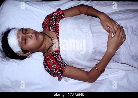 Asian women sleeping in hospital, Injured at head and laying on bed, Concept of caring during covid-19, corona virus Stock Photo
