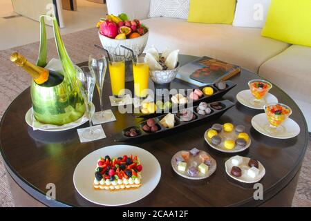 Luxury welcome food on wooden table in a beautiful tropical resort room  background, morning time holiday vacation concept. Cheval Blanc Resort Stock Photo