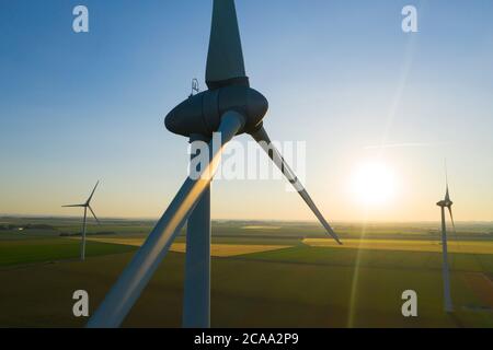 Aerial view of Wind turbines Energy Production - aerial shot on sunset Stock Photo