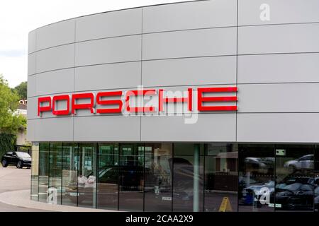 Porsche company logo seen on one of their car dealerships showrooms in London. Stock Photo