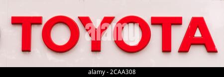Toyota company logo seen on one of their car dealerships showrooms in London. Stock Photo
