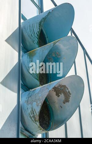 Three metal pipes of an industrial aeration on the putside of a factory Stock Photo