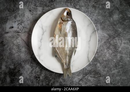 Salted and dried fish on a plate Stock Photo