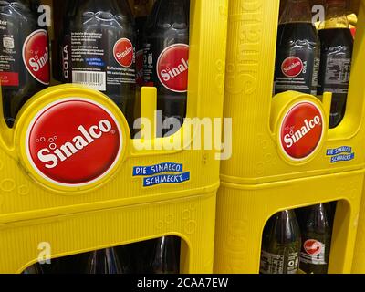 Viersen, Germany - July 9. 2020: View on isolated stacked yellow Sinalco soft drink crates in german beverage store Stock Photo