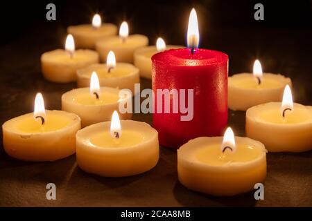 The odd one - Playing with different colored candles. Selective focus Stock Photo