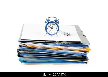 alarm clock on stack of paper and folders, concept for paperwork Stock Photo