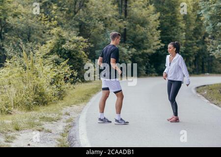 Young female defending herself from an attacher with karate moves. Stock Photo