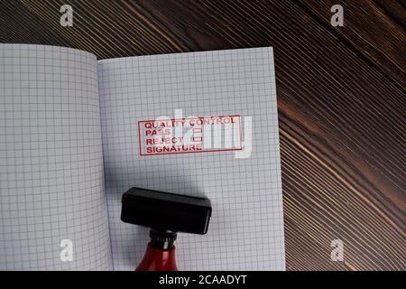 Red Handle Rubber Stamper and Quality Control, Pass, Reject and Signature text isolated on the table. Stock Photo
