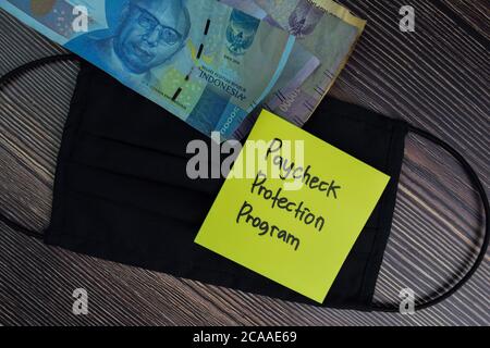 Paycheck Protection Program write on sticky notes isolated on office desk. Stock Photo