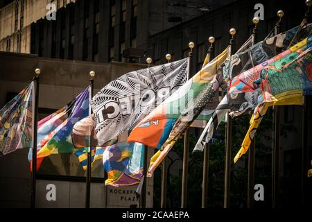 The flag designed by Jenny Holzer, center, joins the 193 flags surrounding the rink at Rockefeller Center in New York showcasing the work of individuals who designed flags to show their love of New York, seen on opening day, August 1, 2020. Rockefeller Center put out a call for designs for flags, from people with all artistic abilities, which represent their love of New York for the temporary exhibit which will run through August 16. Several notable artists also participated. (© Richard B. Levine) Stock Photo