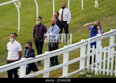 A general view as the grooms watch the action on the big screen at Lingfield Park Racecourse, Surrey. Stock Photo