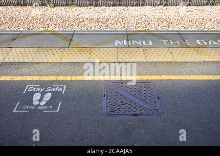 Stay safe, stay apart sprayed on messages at Milton Keynes, railway station Stock Photo