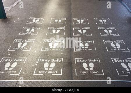 Stay safe, stay apart sprayed on messages at Milton Keynes, railway station Stock Photo