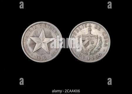 Cuba Cuban silver coin 1 one peso 1916, shield with designs flanked by sprigs, denomination below, star on radiant background in center, purity info a Stock Photo