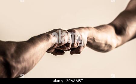 People bumping their fists together, arms. Friendly handshake, friends greeting. Man giving fist bump. Hands of man people fist bump team teamwork Stock Photo