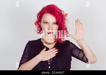Woman witness making a promise or testifies hands gesture. Red head curly bob hairstyle girl isolated light gray grey white background. Mixed race lat Stock Photo