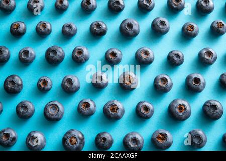 Blueberry pattern on blue background. Ripe blueberries texture close up. Stock Photo