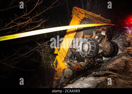 Snow truck falls off road Stock Photo